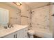 Bathroom featuring marble-like tiling in shower/tub, and white sink vanity at 10115 Tree Bark St, Las Vegas, NV 89183