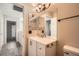 Bathroom with vanity, decorative mirror, and toilet at 10115 Tree Bark St, Las Vegas, NV 89183