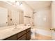 Bathroom boasts shower over tub with white tile surround, vanity, and toilet at 10115 Tree Bark St, Las Vegas, NV 89183