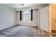 Carpeted bedroom with walk in closet and architectural window at 10115 Tree Bark St, Las Vegas, NV 89183