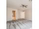 Spacious bedroom with neutral carpet, ceiling fan, walk-in closet, and bath access at 10115 Tree Bark St, Las Vegas, NV 89183