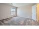 Neutral carpeted bedroom with large window and closet at 10115 Tree Bark St, Las Vegas, NV 89183