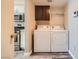 Convenient laundry area with washer, dryer, and storage cabinets at 10115 Tree Bark St, Las Vegas, NV 89183