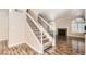Elegant staircase leading to the upper level, adjacent to a cozy fireplace at 10115 Tree Bark St, Las Vegas, NV 89183