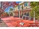 Fully landscaped backyard patio with outdoor kitchen and BBQ, covered patio, dining set, and egg chair at 10490 Palmadora St, Las Vegas, NV 89178