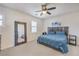 Bright bedroom with a ceiling fan, two windows, and a large mirror at 10490 Palmadora St, Las Vegas, NV 89178