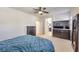 Bright bedroom featuring a ceiling fan, dresser, large mirror and an ensuite bathroom at 10490 Palmadora St, Las Vegas, NV 89178