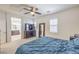 Well-lit bedroom with a TV, a dark wood dresser, and an ensuite bathroom at 10490 Palmadora St, Las Vegas, NV 89178