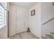 Inviting home entryway featuring tile floors, neutral walls, with simple decor, and a staircase at 10490 Palmadora St, Las Vegas, NV 89178