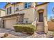 Beautiful two-story home featuring stone accents, a two-car garage, and a charming entryway at 10490 Palmadora St, Las Vegas, NV 89178