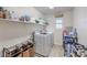 Functional laundry room with modern appliances and ample storage space on shelves at 10490 Palmadora St, Las Vegas, NV 89178