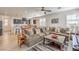 Open-concept living room featuring a large sectional sofa, wood floors, and neutral color palette at 10490 Palmadora St, Las Vegas, NV 89178