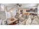 Bright, open-concept living room with hardwood floors, a ceiling fan, and access to the kitchen at 10490 Palmadora St, Las Vegas, NV 89178