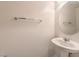 Powder room featuring a pedestal sink, modern chrome fixtures, and neutral paint at 10490 Palmadora St, Las Vegas, NV 89178