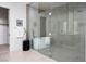 Modern bathroom featuring a glass-enclosed shower and a sleek soaking tub at 10921 Rossa Peak Ave, Las Vegas, NV 89135