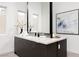 Bathroom vanity with double sinks, large mirror, and white quartz countertops at 10921 Rossa Peak Ave, Las Vegas, NV 89135
