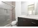 Bathroom features a modern vanity, tiled shower with glass door, and updated fixtures at 10921 Rossa Peak Ave, Las Vegas, NV 89135