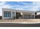 Modern home featuring stone accents, a two-car garage, and desert landscaping at 10921 Rossa Peak Ave, Las Vegas, NV 89135