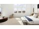 Bright main bedroom with large windows and comfortable seating area at 10921 Rossa Peak Ave, Las Vegas, NV 89135