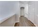 Hallway featuring wood-look floors and a smooth transition through an arched doorway at 11028 Meadow Leaf Ave, Las Vegas, NV 89144