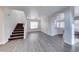 Open-concept living space with modern flooring and staircase showcases a seamless, welcoming design at 11028 Meadow Leaf Ave, Las Vegas, NV 89144