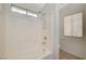 Bathroom featuring a combined shower and tub with white tile and a window at 1115 Pearl Marble Ave, North Las Vegas, NV 89081