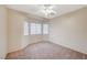 Bedroom with neutral walls, carpet, a ceiling fan, and three bright windows at 1115 Pearl Marble Ave, North Las Vegas, NV 89081