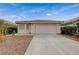 Inviting home exterior with a two-car garage, easy-care landscape, and a classic tile roof at 1115 Pearl Marble Ave, North Las Vegas, NV 89081