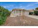 Charming single-story home featuring a tiled roof, low maintenance landscaping, and an attached two-car garage at 1115 Pearl Marble Ave, North Las Vegas, NV 89081