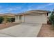 Attractive single-Gathering home displaying a two-car garage, desert landscaping, and a beautiful tiled roof at 1115 Pearl Marble Ave, North Las Vegas, NV 89081