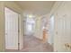 Open hallway featuring neutral carpet flooring, multiple doorways, and arched entryways to the living space at 1115 Pearl Marble Ave, North Las Vegas, NV 89081