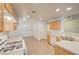 Well-lit kitchen featuring white countertops, light wood cabinets, and linoleum flooring extending into the dining area at 1115 Pearl Marble Ave, North Las Vegas, NV 89081