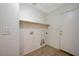 Functional laundry room with tile flooring, utility connections, and an overhead shelf for storage at 1115 Pearl Marble Ave, North Las Vegas, NV 89081