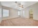 Spacious main bedroom with neutral walls, carpet, ceiling fan, large windows, and walk-in closet at 1115 Pearl Marble Ave, North Las Vegas, NV 89081