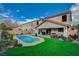 Relaxing backyard oasis includes a refreshing pool, artificial grass, covered patio, and comfortable seating area at 11157 Mezzana St, Las Vegas, NV 89141