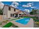 Backyard view showcasing a refreshing pool, lush landscaping, and an outdoor living space, perfect for relaxation at 11157 Mezzana St, Las Vegas, NV 89141
