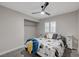 Cozy bedroom featuring a ceiling fan, carpeted floor, natural light, and a closet for ample storage at 11157 Mezzana St, Las Vegas, NV 89141
