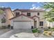 Charming two-story home boasts stucco siding, a red tile roof, and a well-maintained front yard with desert landscaping at 11157 Mezzana St, Las Vegas, NV 89141