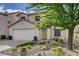 Inviting two-story house has desert landscaping, stucco exterior, a red tile roof, and an attached two-car garage at 11157 Mezzana St, Las Vegas, NV 89141