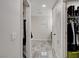 Hallway featuring multiple storage closets with a gray tiled floor at 11157 Mezzana St, Las Vegas, NV 89141