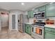 Galley kitchen featuring stainless steel appliances, sage green cabinets, and bright countertop at 11157 Mezzana St, Las Vegas, NV 89141