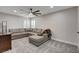 Spacious living room features a cozy sectional couch, carpeted floors, and neutral paint at 11157 Mezzana St, Las Vegas, NV 89141