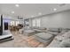 Spacious living room features a plush sectional sofa, a dining area, and ample natural light from shuttered windows at 11157 Mezzana St, Las Vegas, NV 89141
