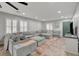 Bright and airy living room is furnished with a large sectional sofa, stylish furniture, and shuttered windows at 11157 Mezzana St, Las Vegas, NV 89141