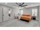 Bright main bedroom with a comfortable bed, modern ceiling fan, and large windows at 11157 Mezzana St, Las Vegas, NV 89141