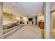Large finished basement features a stepped seating area with a sectional couch and carpeted flooring at 2 Cerchio Centrale, Henderson, NV 89011
