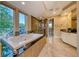 Bright bathroom with large soaking tub, picture windows, and custom tile work at 2 Cerchio Centrale, Henderson, NV 89011