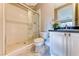 Updated bathroom featuring tiled shower with glass doors, granite countertop, and marble flooring at 2 Cerchio Centrale, Henderson, NV 89011