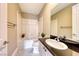 Bright bathroom featuring a tub-shower combo, marble flooring, and a black granite vanity top at 2 Cerchio Centrale, Henderson, NV 89011