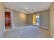 Bright bedroom with carpet flooring, recessed lighting, patio doors leading to a pool, and a walk-in closet at 2 Cerchio Centrale, Henderson, NV 89011
